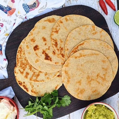 Almond flour tortillas laid out on a woode board