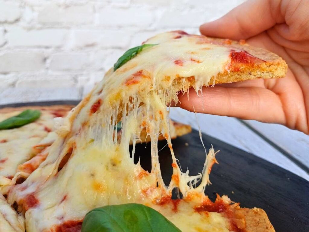 A slice of cheesy almond flour pizza crust