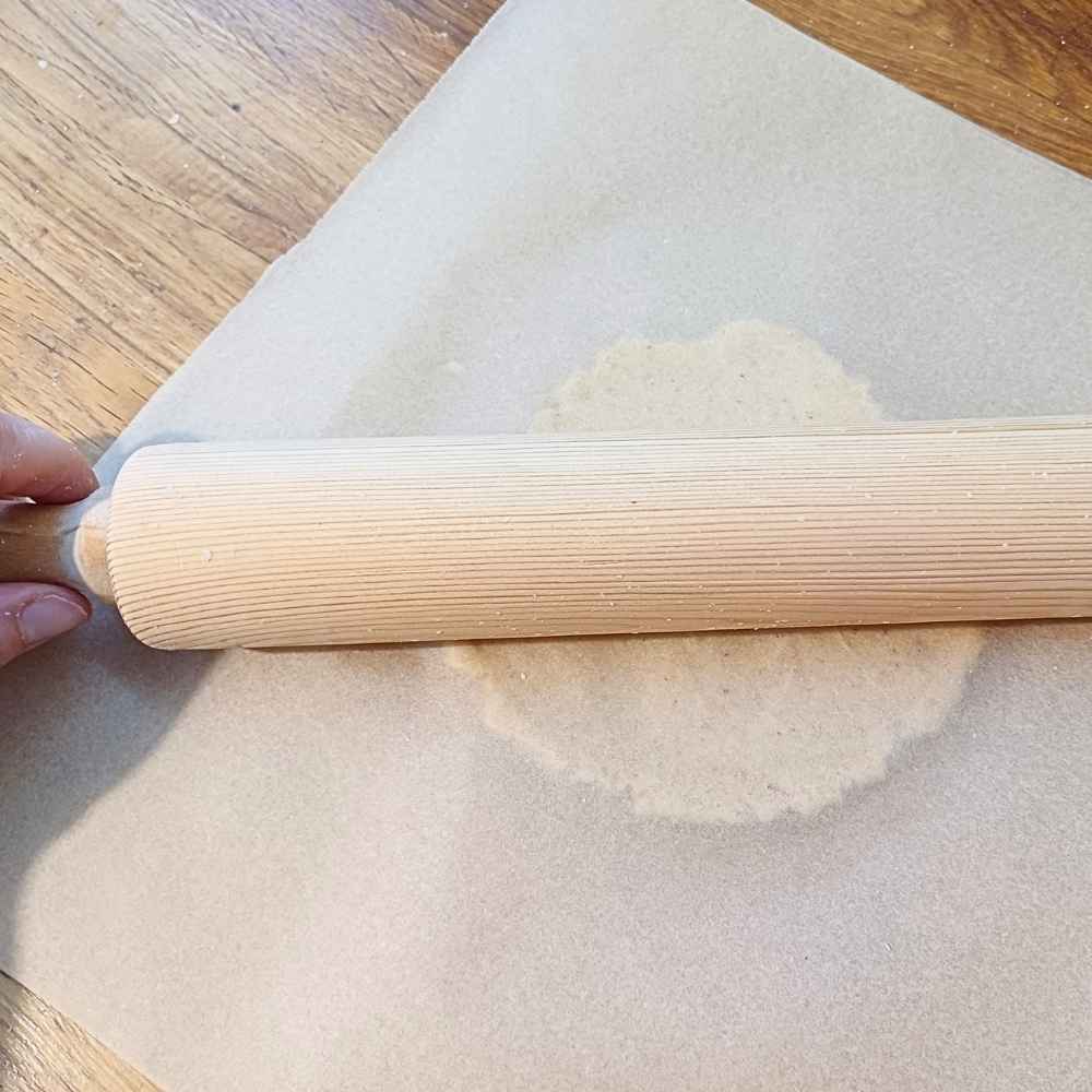 Rolling out dough for almond flour pizza