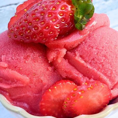 Strawberry sorbet Ninja Creami recipe topped with fresh strawberries in a serving bowl