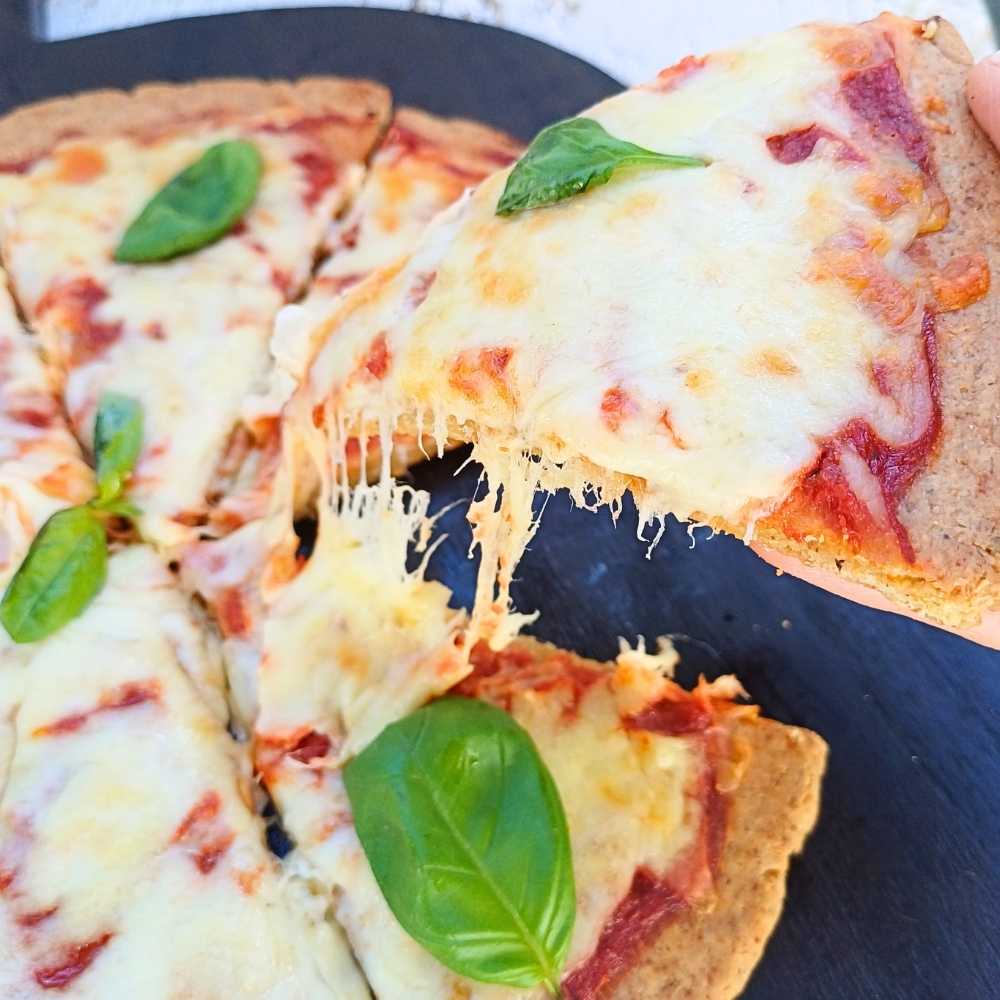 cheesy pizza with basil made on almond flour crust