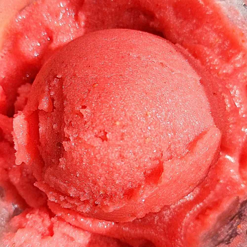 Scoop of strawberry sorbet made with Ninja Creami machine