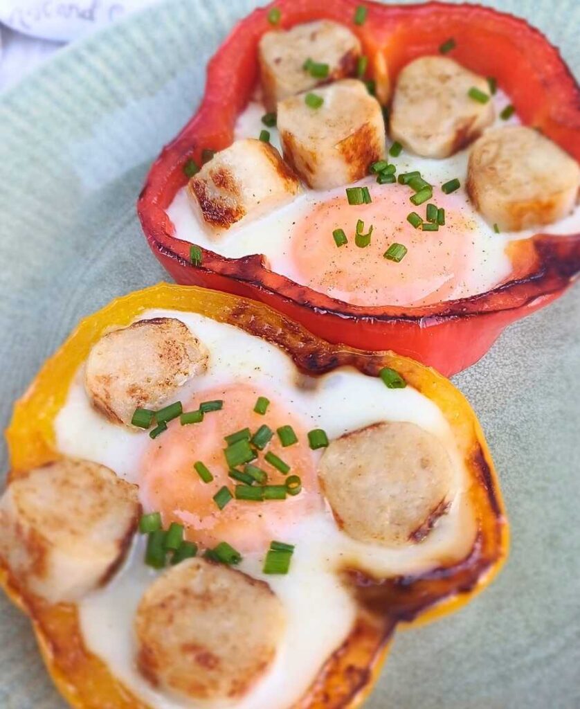 Bell pepper eggs cooked on a skillet with chicken sausage and chives