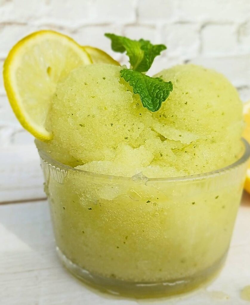 lemon sorbet Ninja Creami with lime and mint in glass bowl