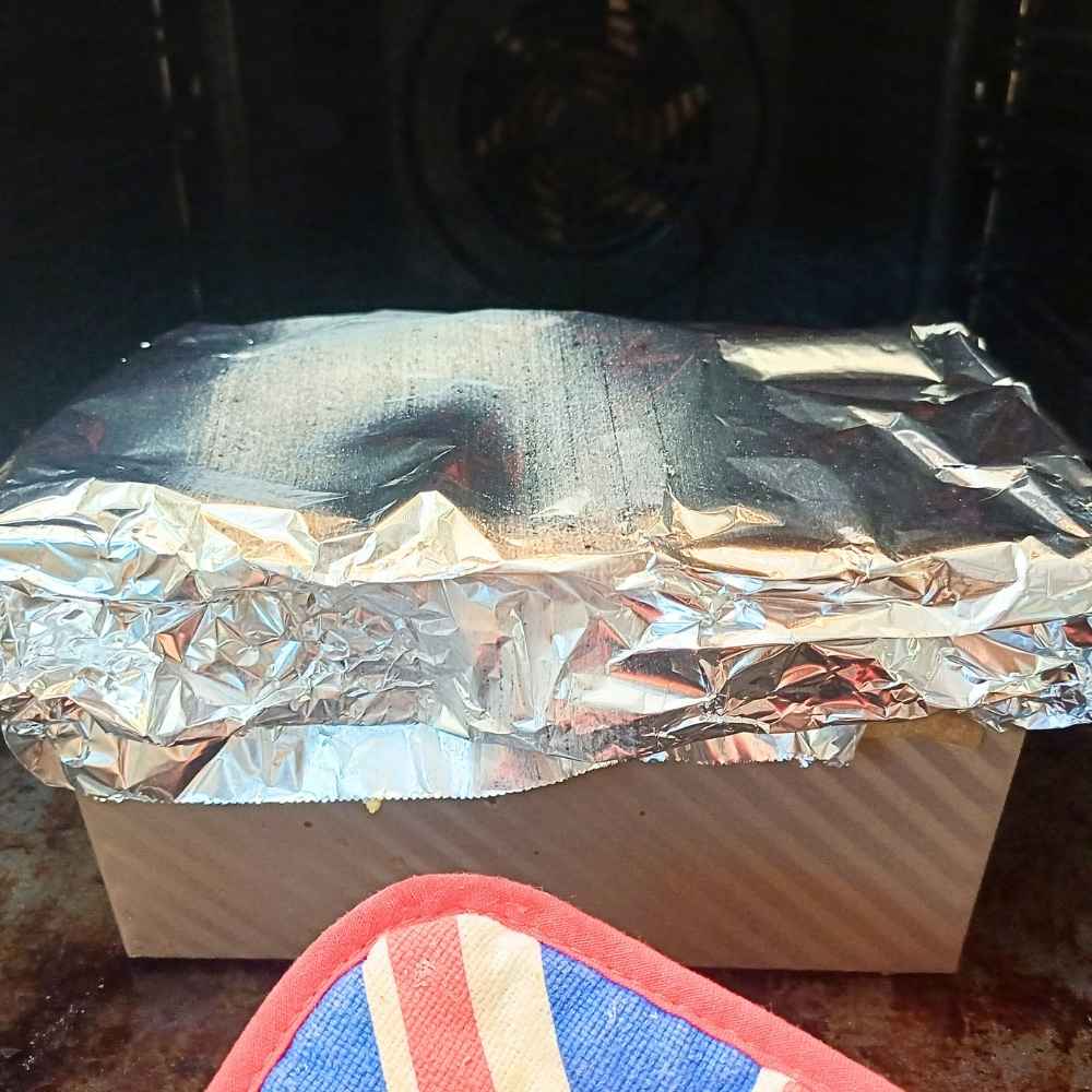 Bread loaf tin going into the oven