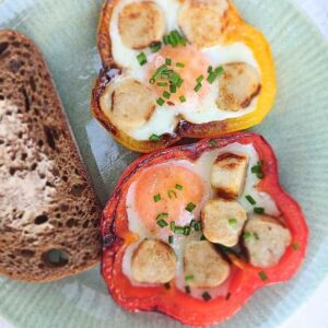 Eggs baked in bell pepper rings with chicken sausage pieces