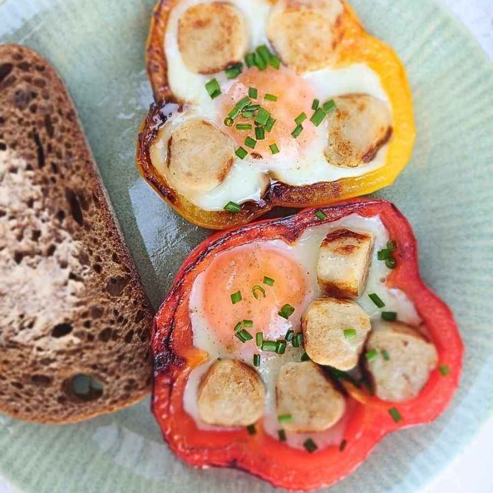 Eggs baked in bell pepper rings with chicken sausage pieces