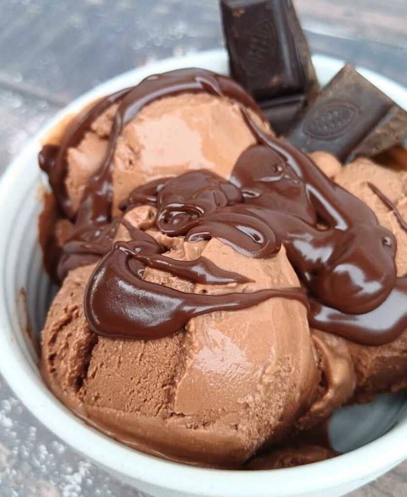 Scoops of rich Ninja Creami chocolate ice cream with melted drizzle
