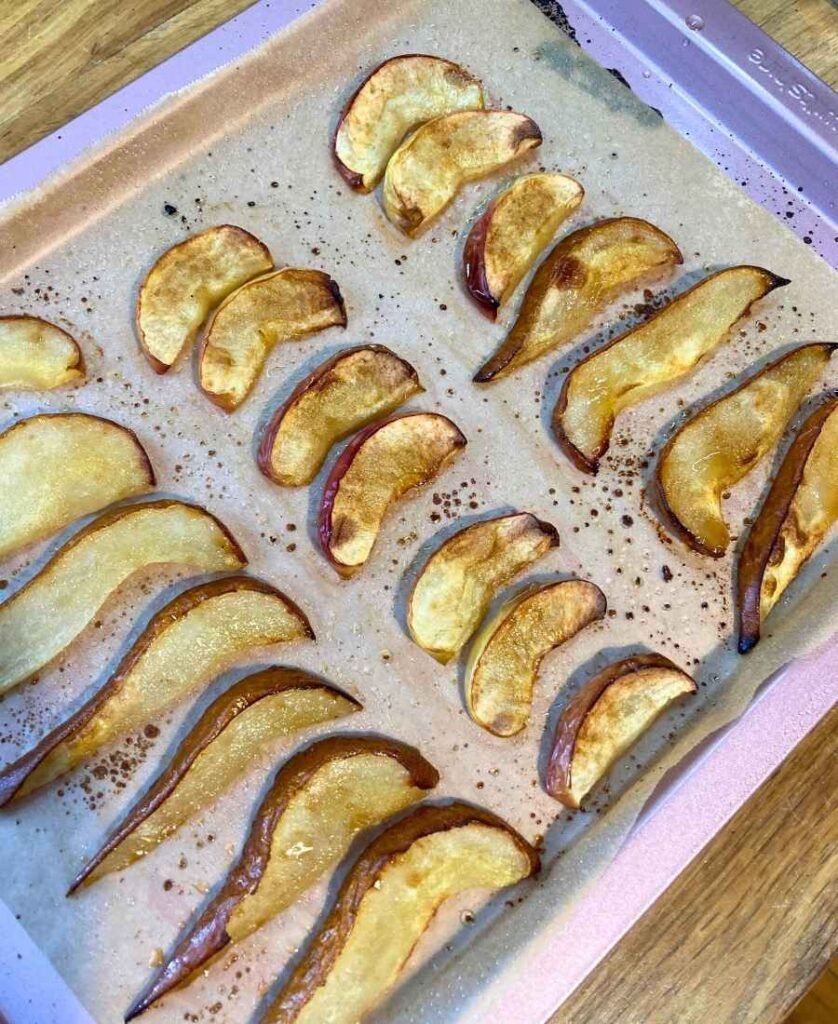 Baked apples and pears on a baking sheet