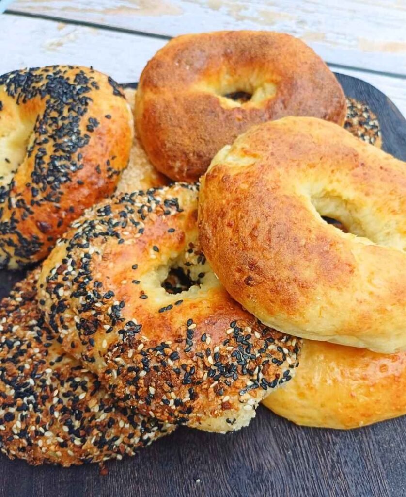Stack of homemade cottage cheese bagels on a board