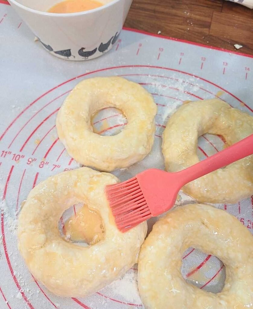 Brushing bagels with egg wash