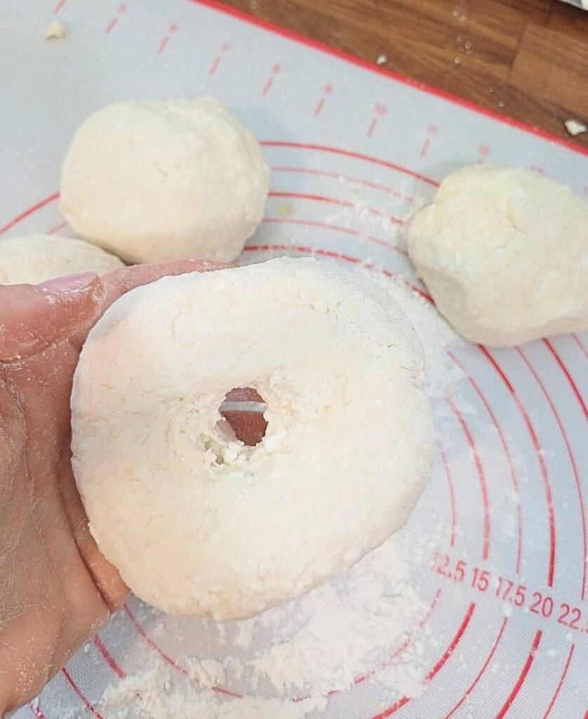 Flattening the bagels and making a hole