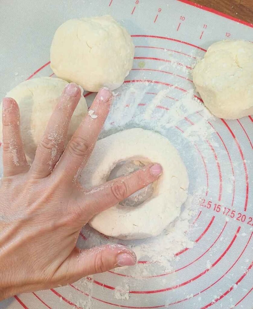 Making a hole in a bagel with hand